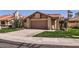 Charming single-story home featuring a two-car garage and desert landscaping at 9803 N 100Th Pl, Scottsdale, AZ 85258