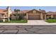 Inviting single-story home with a well-manicured lawn and two-car garage at 9803 N 100Th Pl, Scottsdale, AZ 85258