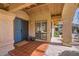 Welcoming front porch with a blue door and tiled flooring at 9803 N 100Th Pl, Scottsdale, AZ 85258