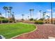 Well-manicured front yard with lush lawn, mature trees, and desert landscaping at 9803 N 100Th Pl, Scottsdale, AZ 85258