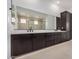 Bright bathroom featuring double sinks, sleek cabinets, quartz countertop, and modern fixtures at 10308 E Utah Ave, Mesa, AZ 85212
