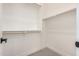 Walk-in closet with white walls, wood shelves and a carpet floor at 10308 E Utah Ave, Mesa, AZ 85212