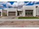 Contemporary home featuring a three car garage and a well-manicured lawn at 10308 E Utah Ave, Mesa, AZ 85212