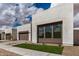 Contemporary home featuring a three car garage and a well-manicured lawn at 10308 E Utah Ave, Mesa, AZ 85212