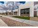 Contemporary home featuring a three car garage and a well-manicured lawn at 10308 E Utah Ave, Mesa, AZ 85212