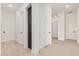 Bright hallway featuring light stone floors, white walls, and modern doors at 10308 E Utah Ave, Mesa, AZ 85212