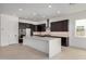 Modern kitchen with stainless steel appliances, large island, and dark wood cabinetry at 10308 E Utah Ave, Mesa, AZ 85212