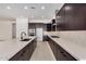 Sleek kitchen with stainless steel appliances, dark wood cabinetry, and quartz countertops at 10308 E Utah Ave, Mesa, AZ 85212