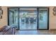 View of outdoor patio and pool area with dining table and seating seen through sliding glass doors at 105 E Claremont St, Phoenix, AZ 85012