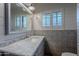 Bathroom with a large mirror, marble countertop, and patterned tile accent wall at 105 E Claremont St, Phoenix, AZ 85012