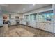 Spacious kitchen featuring white cabinets, stainless steel appliances, granite countertops, and a decorative tile floor at 105 E Claremont St, Phoenix, AZ 85012