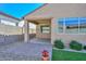 Covered patio overlooking a backyard with pavers, lush artificial turf, and privacy walls at 10730 W Escuda Dr, Peoria, AZ 85373