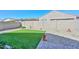 A backyard with artificial turf, desert landscaping, and a paved patio area at 10730 W Escuda Dr, Peoria, AZ 85373