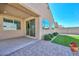 Covered patio overlooking the well-maintained backyard with pavers, artificial turf, and a privacy wall at 10730 W Escuda Dr, Peoria, AZ 85373