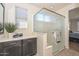 Charming bathroom with a glass enclosed shower and granite countertop at 10730 W Escuda Dr, Peoria, AZ 85373