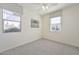 Bright bedroom featuring neutral tones, dual windows, and a ceiling fan providing ample natural light at 10730 W Escuda Dr, Peoria, AZ 85373