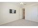 Well-lit bedroom with a ceiling fan, a TV mounted on the wall, and closet with sliding doors at 10730 W Escuda Dr, Peoria, AZ 85373
