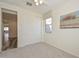 Neutral bedroom with carpet floors features a closet and a window with a roller shade and a decorative painting at 10730 W Escuda Dr, Peoria, AZ 85373