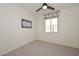 Neutral-colored bedroom with carpet and a window at 10730 W Escuda Dr, Peoria, AZ 85373