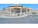 Front view of the community clubhouse featuring stone accents, a fountain, and ample parking at 10730 W Escuda Dr, Peoria, AZ 85373