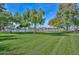 Well-manicured community park with lush green grass, mature trees, and a lake view at 10730 W Escuda Dr, Peoria, AZ 85373
