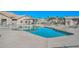 Community pool featuring clear blue water, lounge chairs, and a shaded seating area at 10730 W Escuda Dr, Peoria, AZ 85373