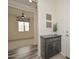 Home entryway showcases attractive gray flooring leading into a carpeted room, complemented by a stylish storage console at 10730 W Escuda Dr, Peoria, AZ 85373