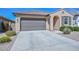 Single-story home featuring a tile roof, desert landscaping, and driveway leading to a two-car garage at 10730 W Escuda Dr, Peoria, AZ 85373