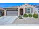 Charming single-story home featuring a tile roof, desert landscaping and two-car garage at 10730 W Escuda Dr, Peoria, AZ 85373