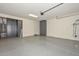 Spacious garage with gray painted floor, equipped with storage cabinets and overhead lighting at 10730 W Escuda Dr, Peoria, AZ 85373