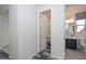 Hallway with a peek to the bathroom and a closet with shelves at 10730 W Escuda Dr, Peoria, AZ 85373