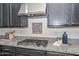 Close-up of granite countertops with gas range and stainless steel hood at 10730 W Escuda Dr, Peoria, AZ 85373