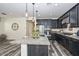 Modern kitchen with granite countertops, stainless steel appliances, and dark wood cabinetry at 10730 W Escuda Dr, Peoria, AZ 85373