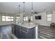 This kitchen features a gray island with granite countertops and stainless steel appliances at 10730 W Escuda Dr, Peoria, AZ 85373