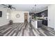Open-concept kitchen and living room with dark wood cabinets and island at 10730 W Escuda Dr, Peoria, AZ 85373