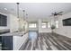 Open-concept living room and kitchen with sleek flooring and abundant natural light at 10730 W Escuda Dr, Peoria, AZ 85373