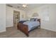 Main bedroom showcases a wooden bed frame, light hard wood flooring, and an ensuite bathroom at 10730 W Escuda Dr, Peoria, AZ 85373