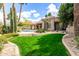 An expansive backyard features lush grass and desert landscaping, offering a serene outdoor space at 11664 E Del Timbre Dr, Scottsdale, AZ 85259