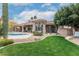 A sprawling backyard with a pristine lawn, desert landscaping, and a pool perfect for relaxation at 11664 E Del Timbre Dr, Scottsdale, AZ 85259