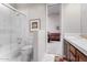 Bathroom showcasing a tub, toilet, and vanity with a view of the bedroom at 11664 E Del Timbre Dr, Scottsdale, AZ 85259