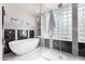 Bright bathroom features a soaking tub, walk-in shower with glass block windows, and marble accents at 11664 E Del Timbre Dr, Scottsdale, AZ 85259