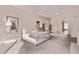 Well-lit bedroom boasts neutral colors, a comfortable bed, and an ensuite bathroom entrance at 11664 E Del Timbre Dr, Scottsdale, AZ 85259