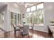 Charming dining area with wood floors, shutters, and views of the backyard at 11664 E Del Timbre Dr, Scottsdale, AZ 85259