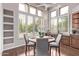 Bright dining area with plantation shutters and a view of the pool at 11664 E Del Timbre Dr, Scottsdale, AZ 85259