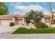 Charming single-story home featuring a well-maintained lawn, desert landscaping and a three car garage at 11664 E Del Timbre Dr, Scottsdale, AZ 85259