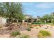 Artistic outdoor water feature and beautiful landscaping enhance this home's curb appeal at 11664 E Del Timbre Dr, Scottsdale, AZ 85259