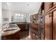 Gourmet kitchen with stainless steel appliances, granite countertops, and custom wood cabinets at 11664 E Del Timbre Dr, Scottsdale, AZ 85259
