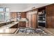 Stylish kitchen featuring granite countertops, custom cabinets, and stainless steel appliances at 11664 E Del Timbre Dr, Scottsdale, AZ 85259