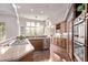 Bright, updated kitchen with stainless steel appliances, granite countertops, and hardwood floors at 11664 E Del Timbre Dr, Scottsdale, AZ 85259