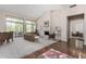 Bright and airy living room featuring a fireplace, large windows and sliding doors for access to the backyard at 11664 E Del Timbre Dr, Scottsdale, AZ 85259